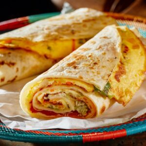 Read more about the article The Ugandan Rolex: A Street Food Icon with a Side of Culture